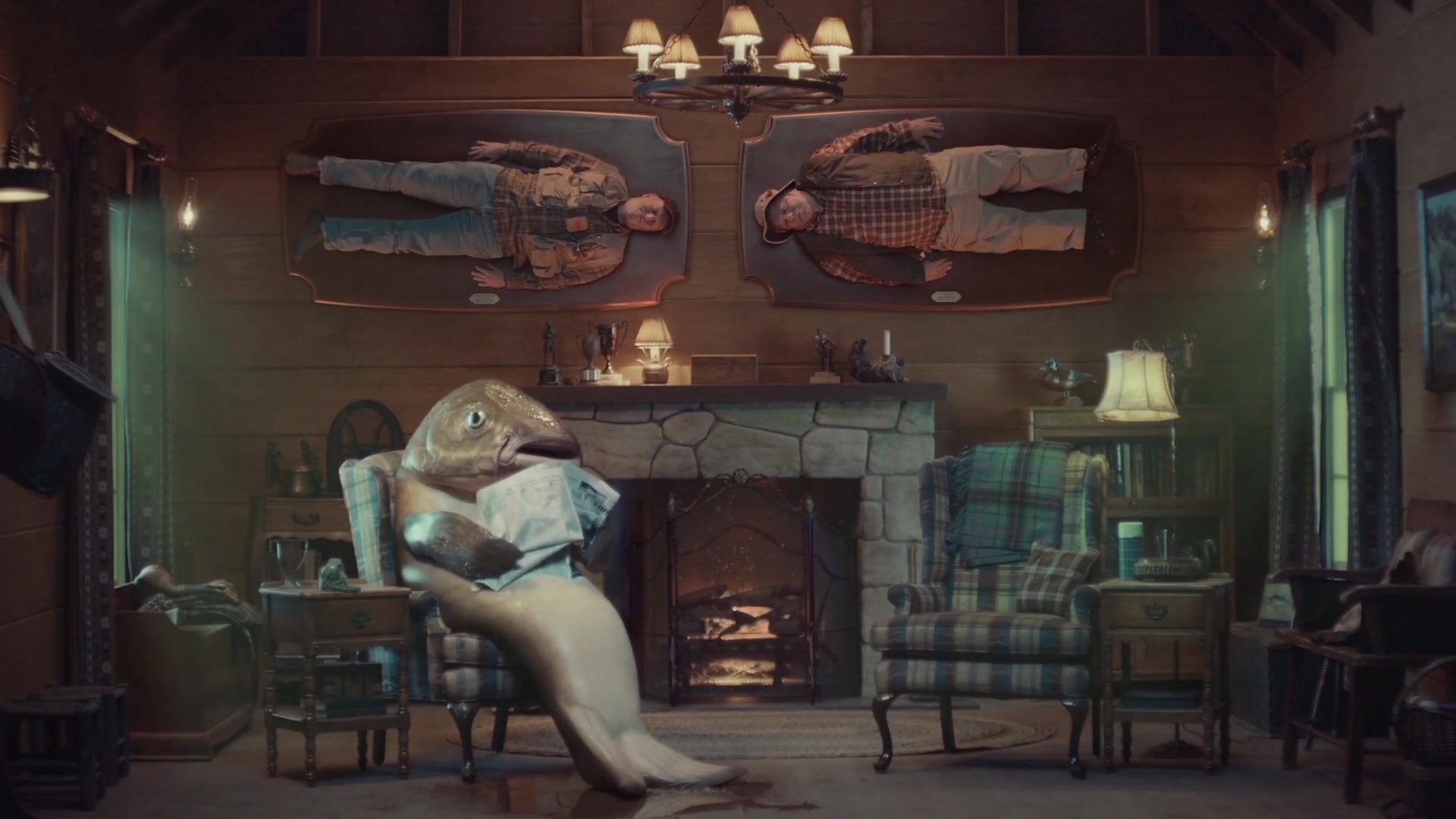 Lake — a giant fish relaxes in an armchair beneath two fishermen mounted above the fireplace