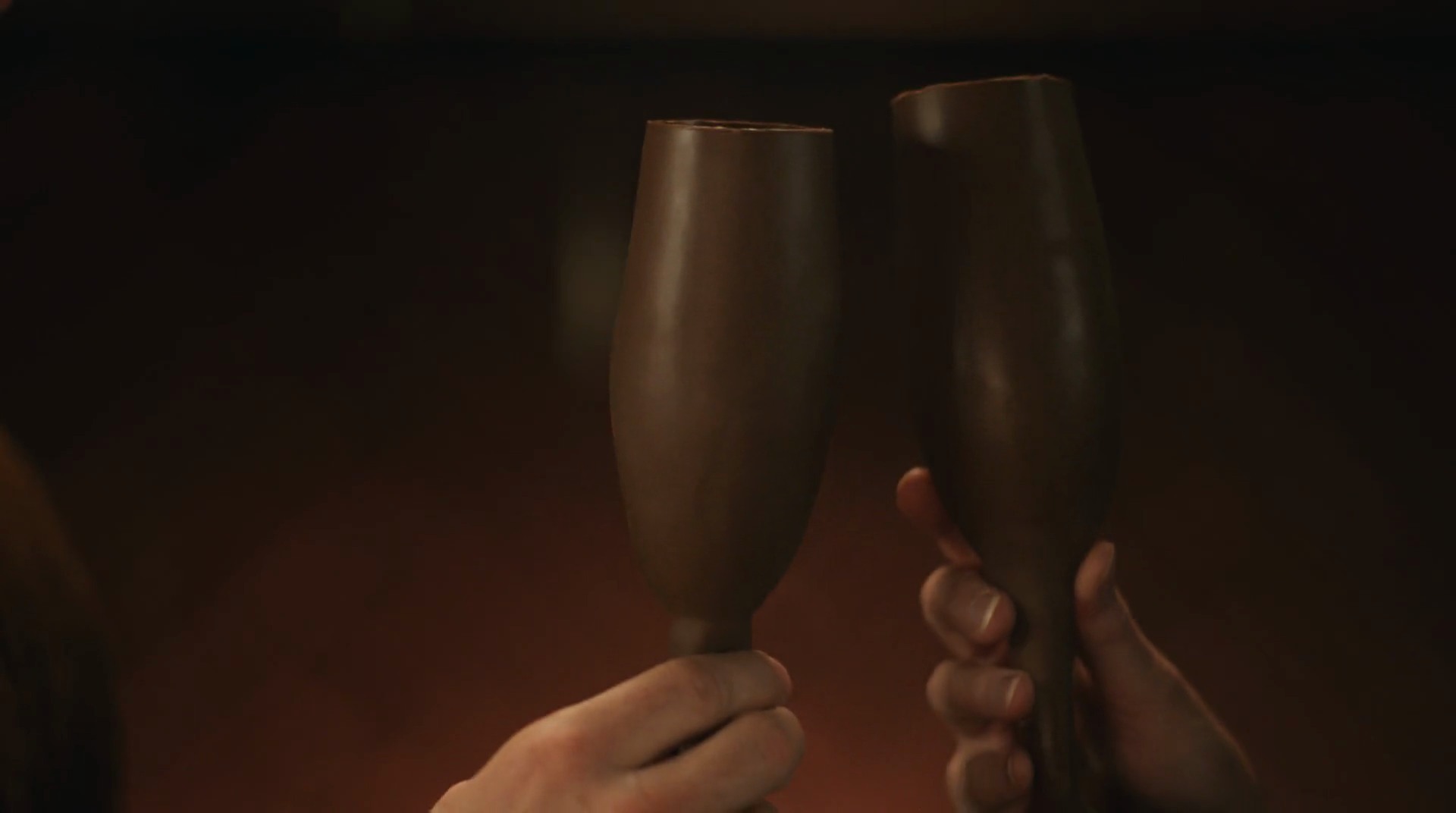 The chocolate-loving audience — the couple toasts with champagne flutes made of chocolate