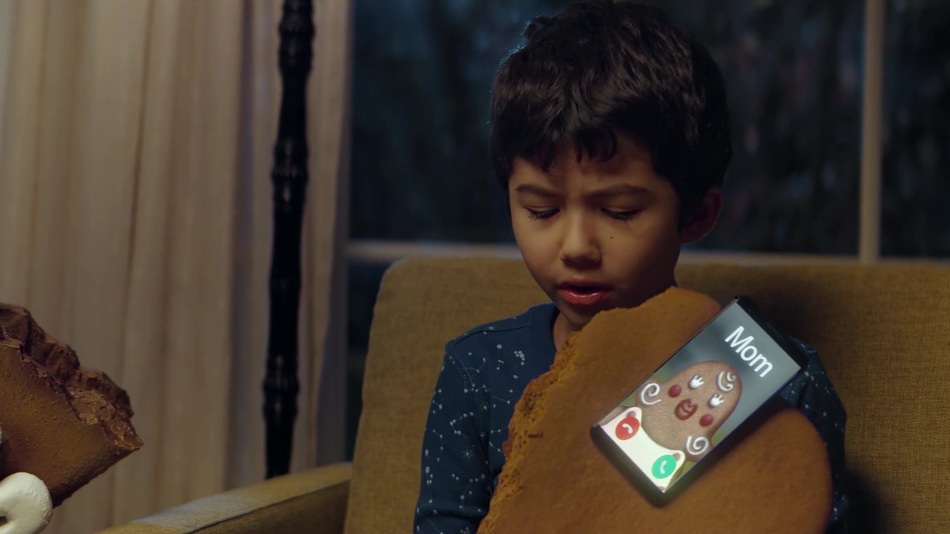 Gingerbread Man — a child holds the bitten cookie hand as its phone rings with a call from Mom