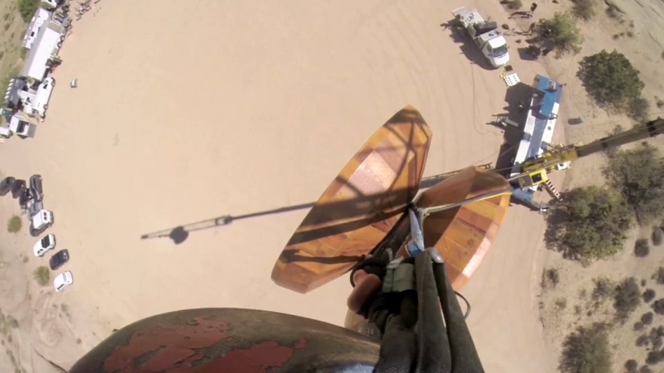 An overhead view of the enormous wooden yo-yo suspended above the desert